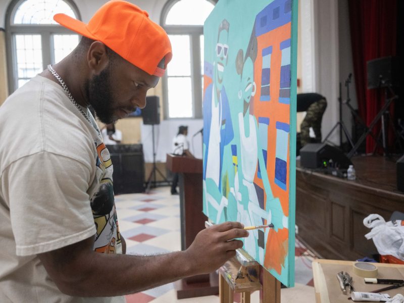 Painter Trey Wilkes showcases his talents in front of a live crowd at the 10th anniversary of Congress Heights Arts and Culture Center (CHACC) on June 19 at the Old Congress Heights School in Southeast D.C. (Khalid Naji-Allah)