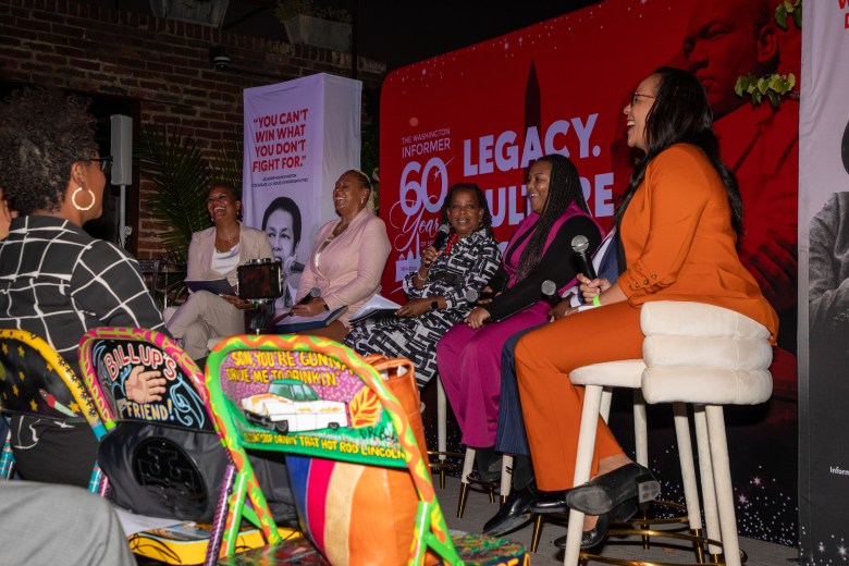 Panelists smiling during chamber discussion at the Washington Informer Visual Legacy Exhibit.