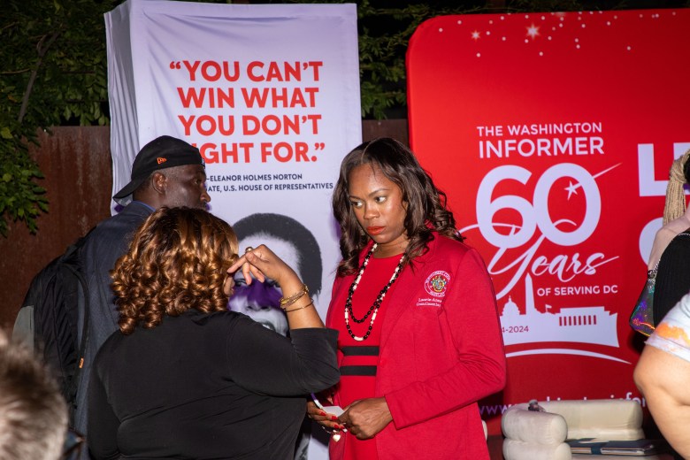 Attendees networking during the Washington Informer Visual Legacy Exhibit reception.