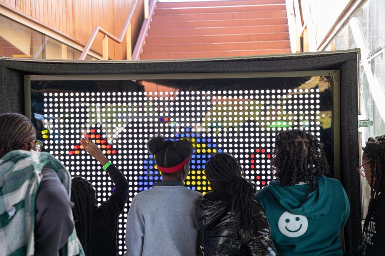 Students explore a large light wall display during the #STEAMtheBlock Party at Gateway DC in Southeast Washington.