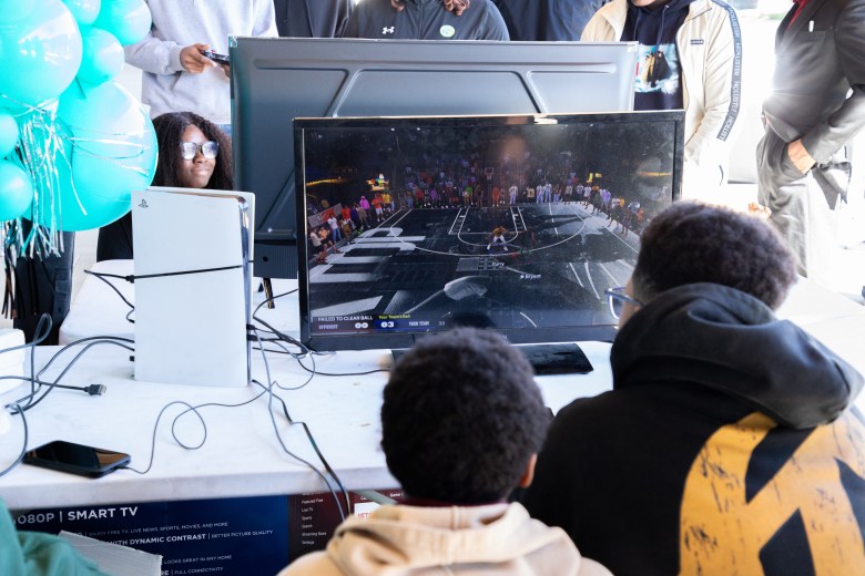 Students play NBA 2K on PlayStation consoles during the #STEAMtheBlock Party at Gateway DC.