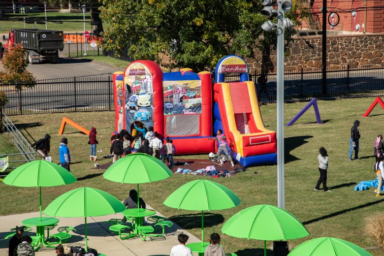 Students climb in and out of the bounce house at the #SteamtheBlock Party.