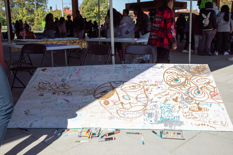 A community art board covered in colorful drawings and signatures at the #STEAMtheBlock Party in Southeast D.C.