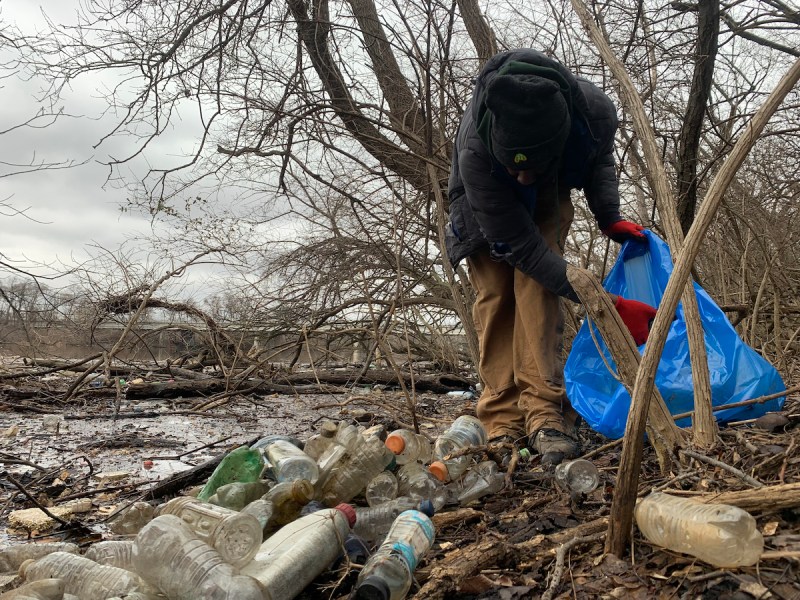 A volunteer contributes to the cleanup of a river in Ward 8. (Kayla Benjamin/The Washington Informer)