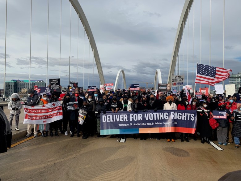 Participants in the annual Dr. Martin Luther King Jr. Peace Walk and Parade cross the Frederick Douglass Memorial Bridge in southeast D.C. on Jan. 17. (Photo by Lafayette Barnes)