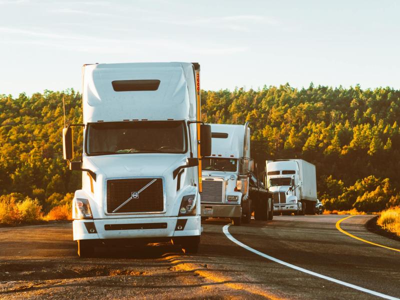 white volvo semi truck on side of road