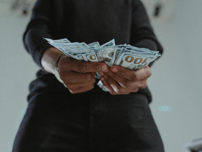 close up photo of a person s hands holding dollar bank notes