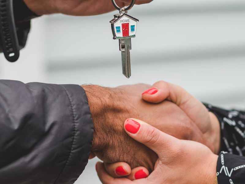 person handing over a key