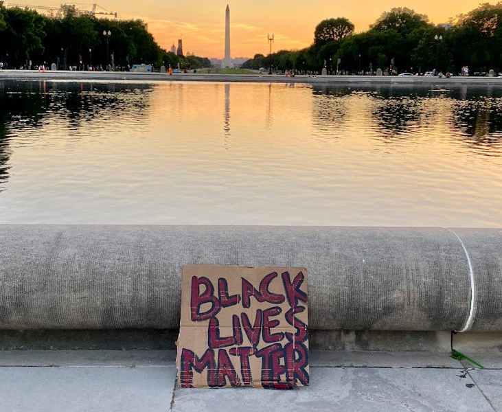 photo of a brown cardboard sign with texts