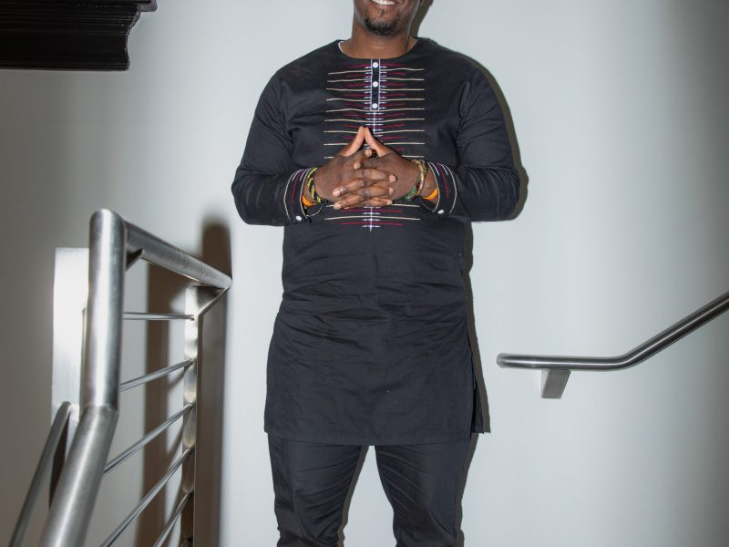 A portrait of Rev. Delonte Gholston taken before the Real Safety D.C. roundtable, standing indoors and looking toward the camera.